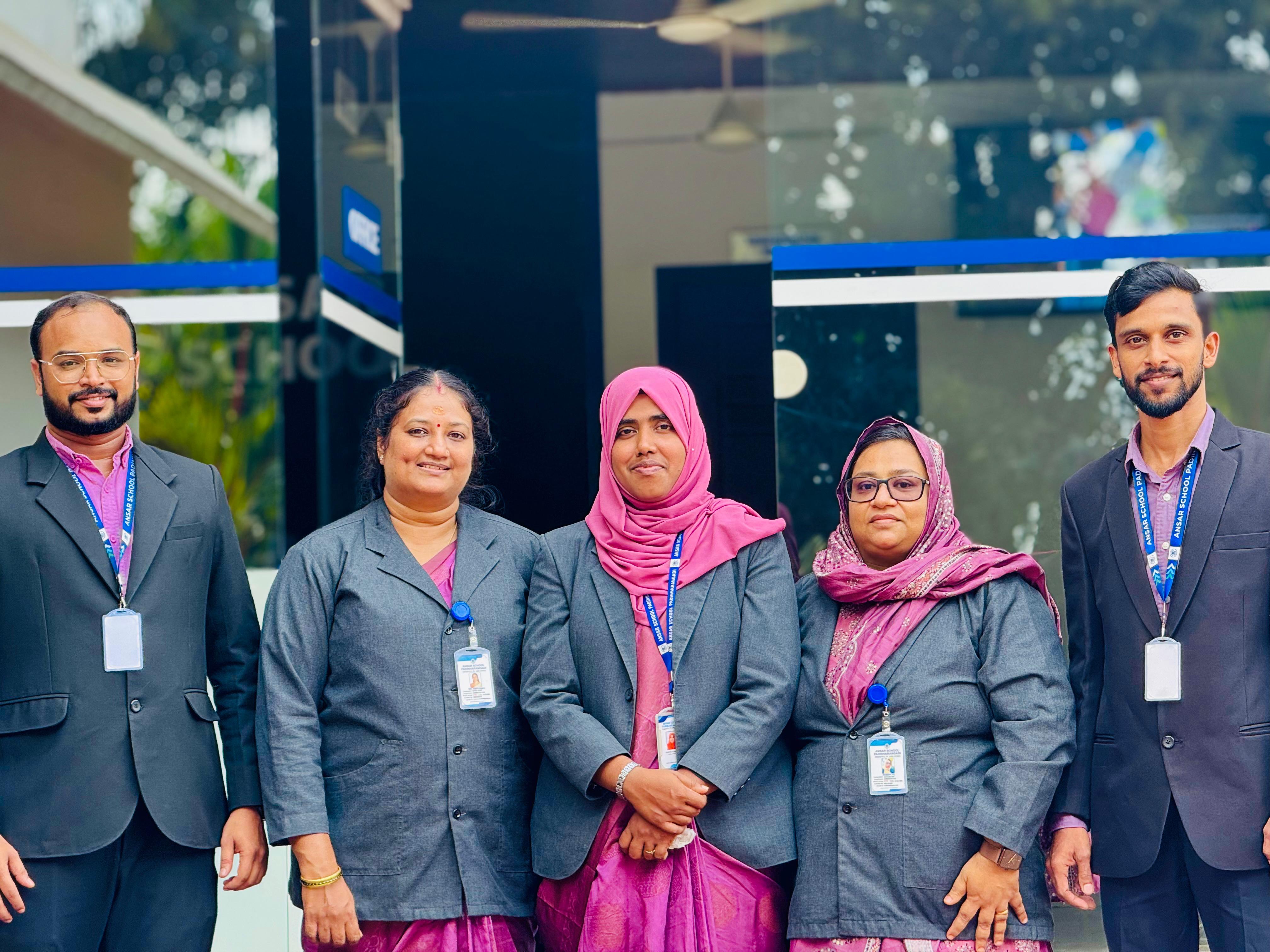 Administrative staff outside the school entrance