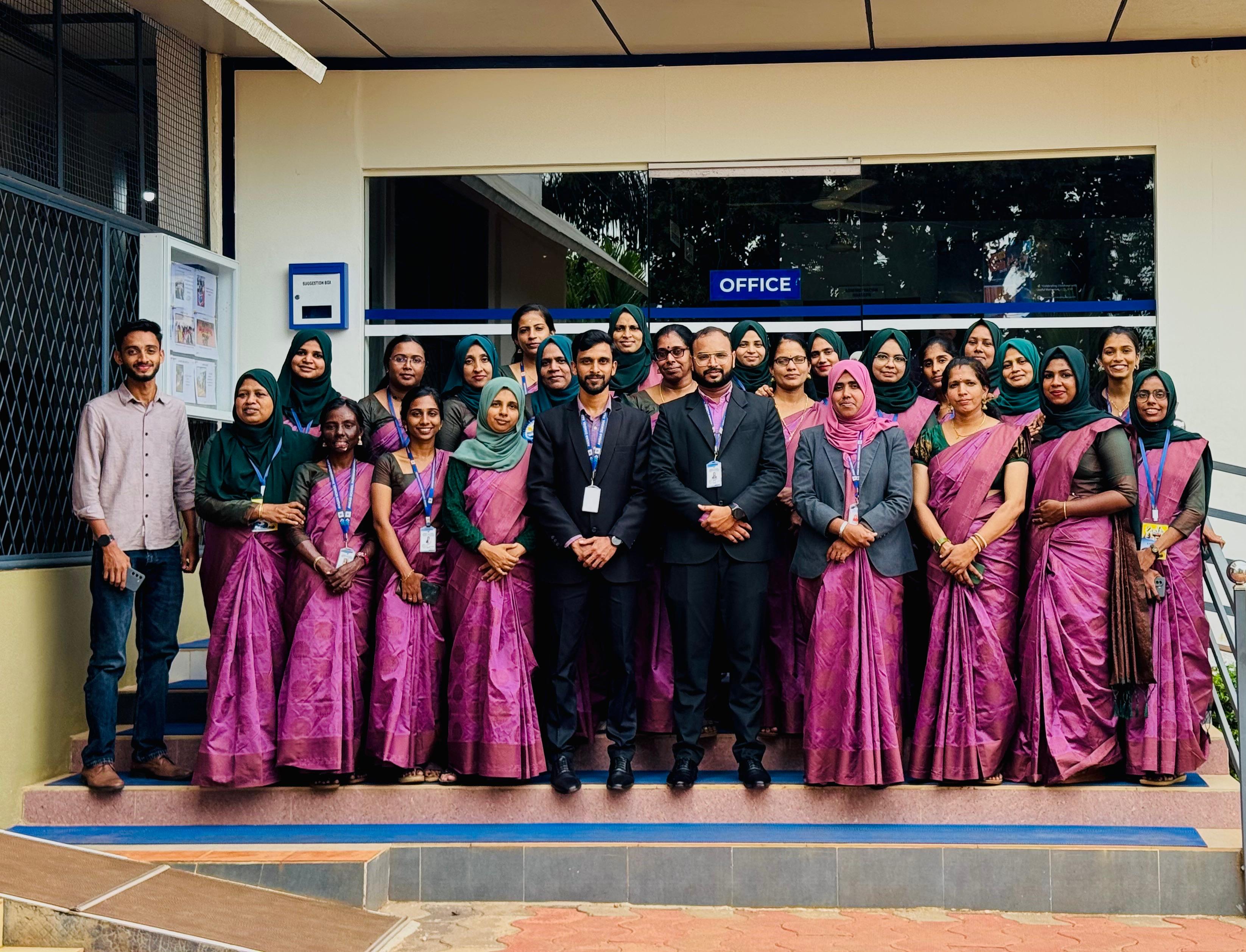 Ansar School team posed on the office steps